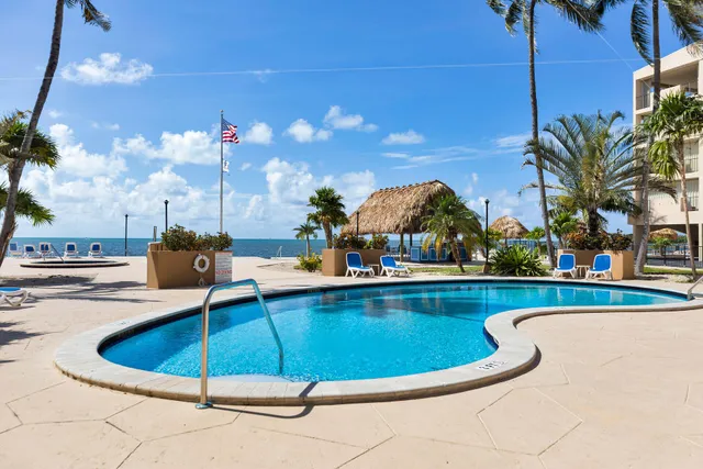 a view of a swimming pool with a table and chairs