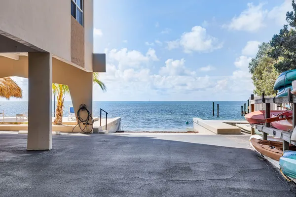 a view of a lake with lawn chairs