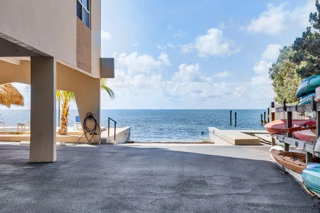 a view of a lake with lawn chairs