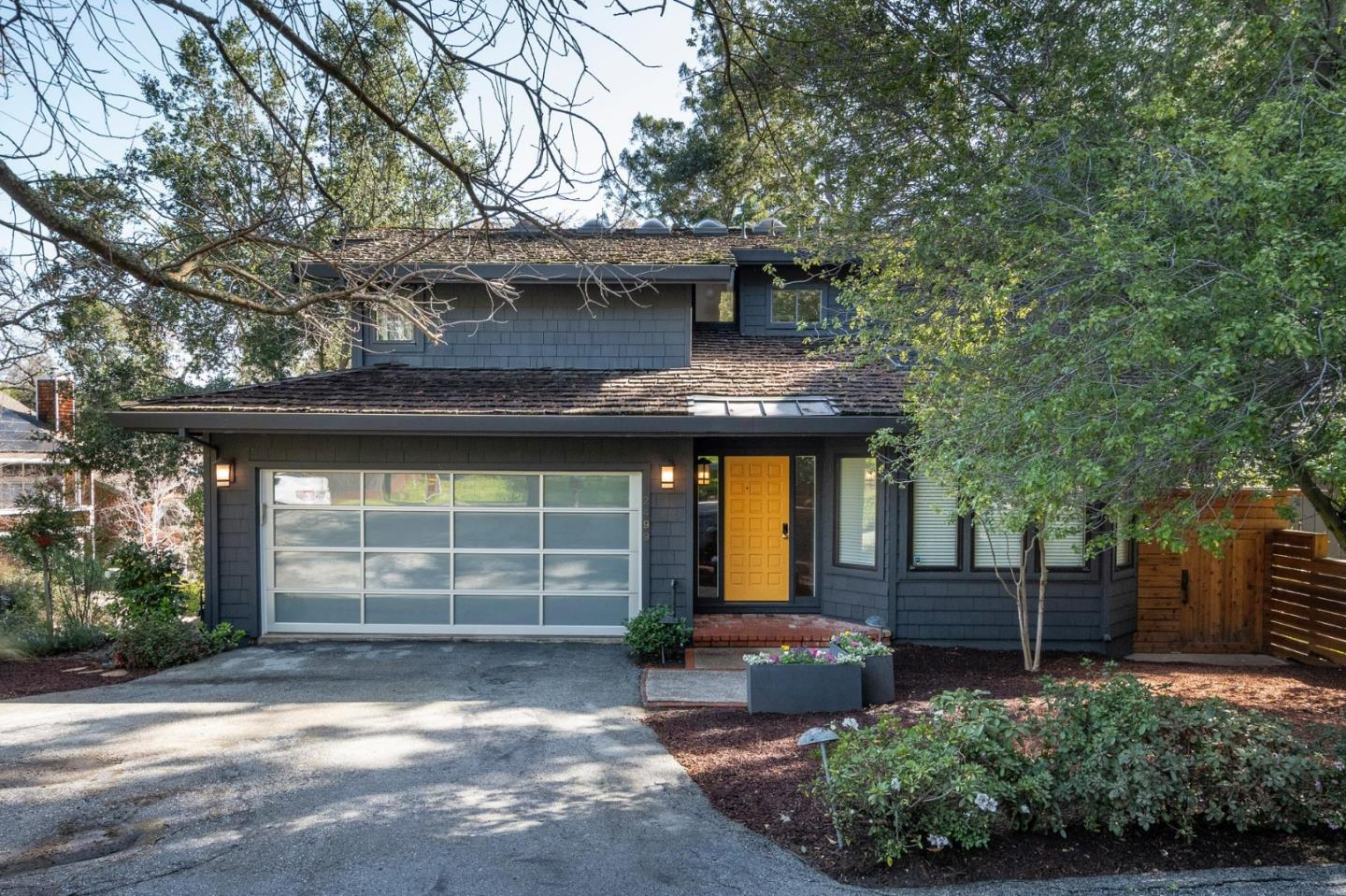 a front view of a house with a garden
