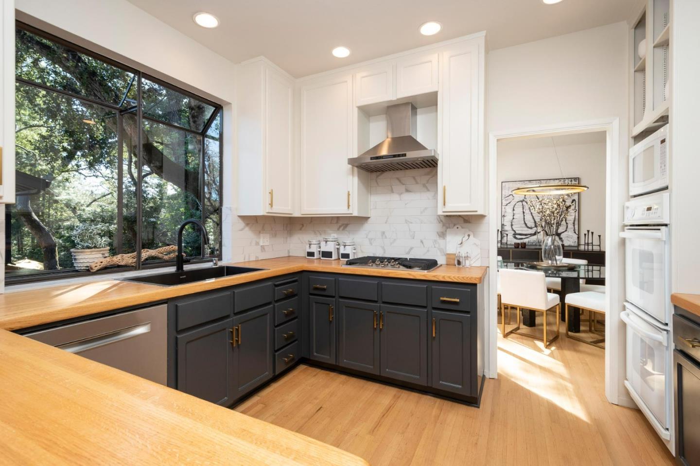 2499 Alpine Road Menlo Park, CA 94025 - Photo 8 of 28 a kitchen with stainless steel appliances granite countertop a sink stove and wooden cabinets