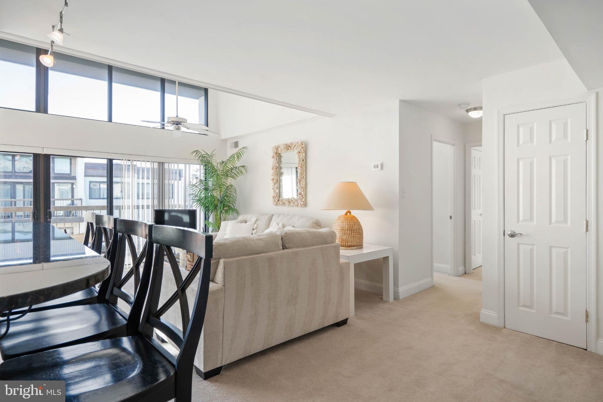 13908 North Ocean Road, Unit 10A Ocean City, MD 21842 - Photo 12 of 29 a living room with furniture and a large window