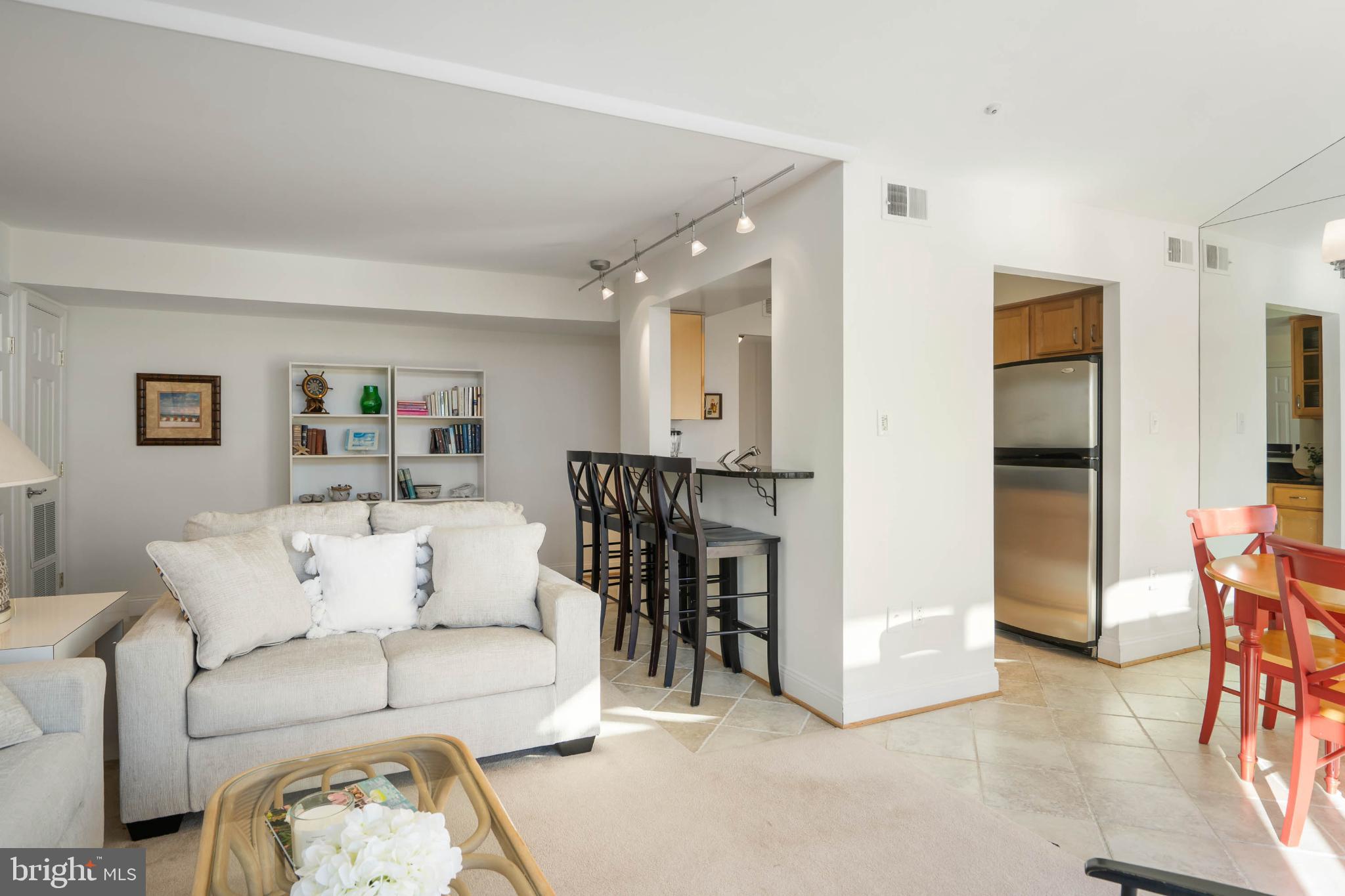 13908 North Ocean Road, Unit 10A Ocean City, MD 21842 - Photo 15 of 29 a living room with furniture and a table