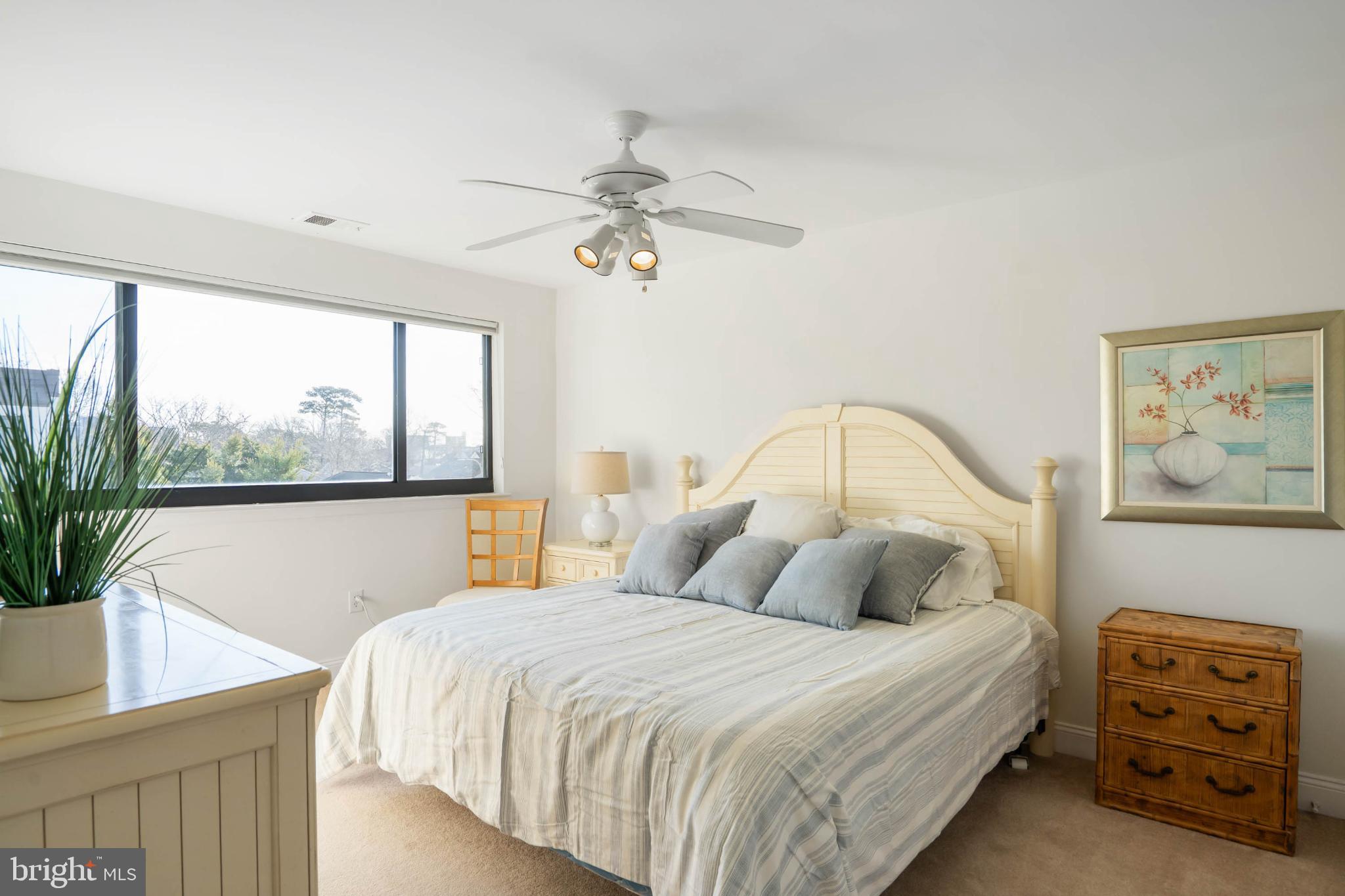 13908 North Ocean Road, Unit 10A Ocean City, MD 21842 - Photo 17 of 29 a bedroom with a bed and a painting on the wall