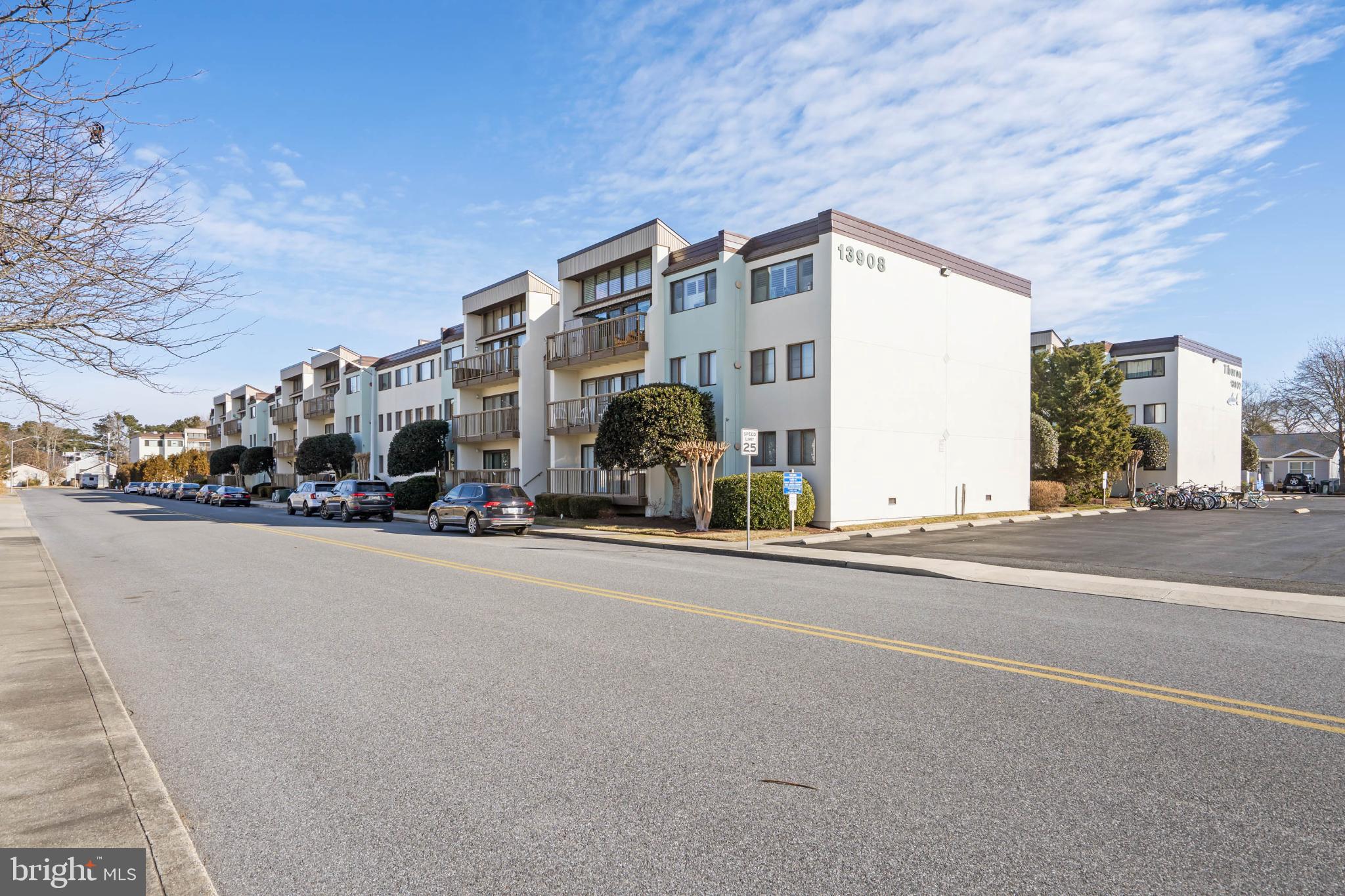 13908 North Ocean Road, Unit 10A Ocean City, MD 21842 - Photo 2 of 29 a group of cars parked in front of a building