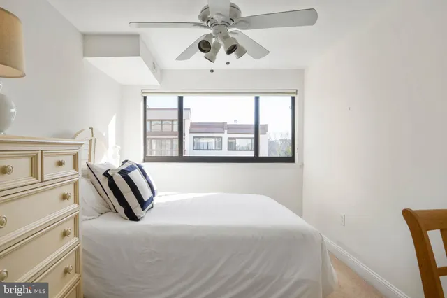 a bathroom with a granite countertop sink a mirror and a toilet