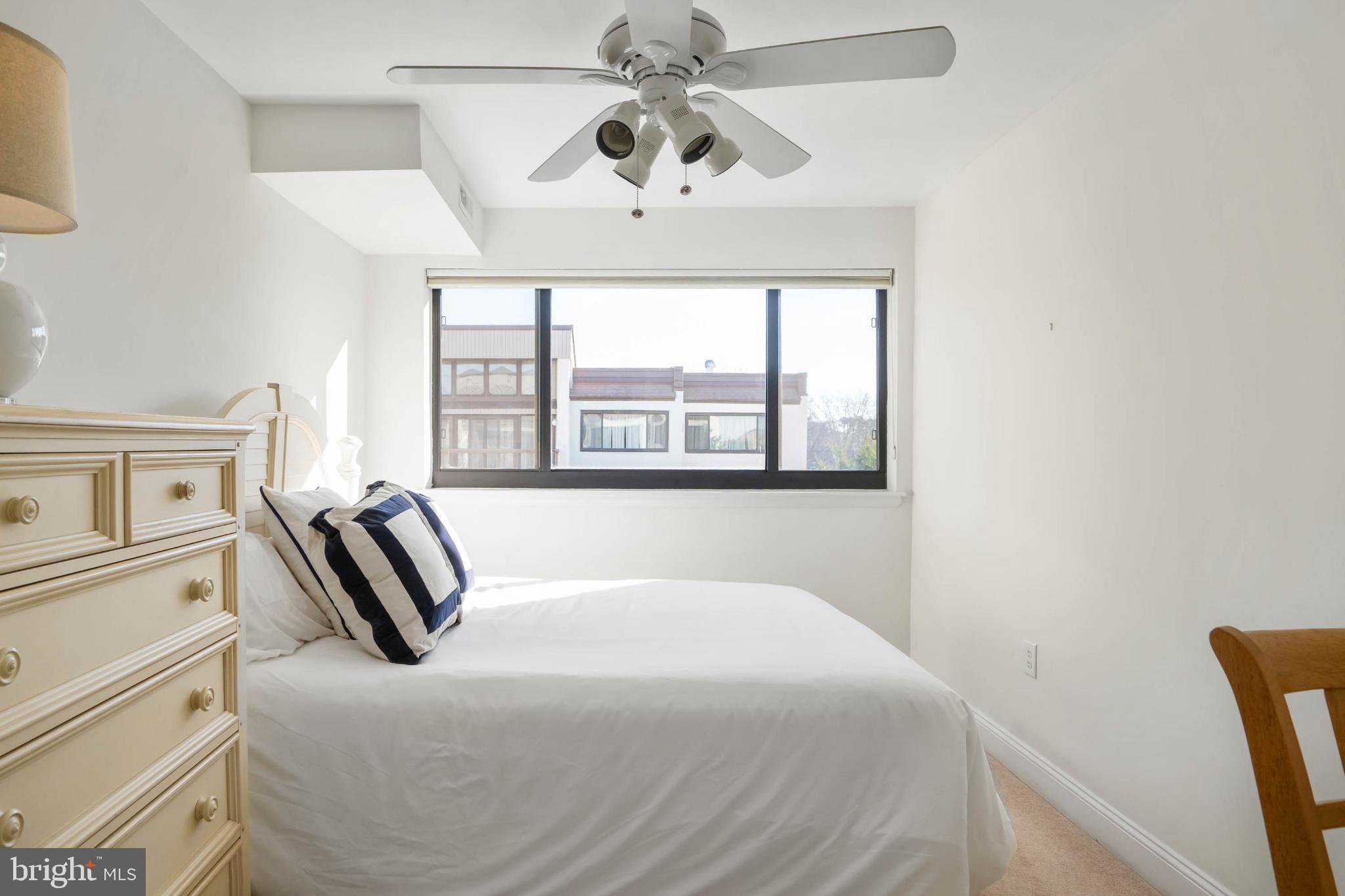 13908 North Ocean Road, Unit 10A Ocean City, MD 21842 - Photo 20 of 29 a bedroom with a large bed and a window