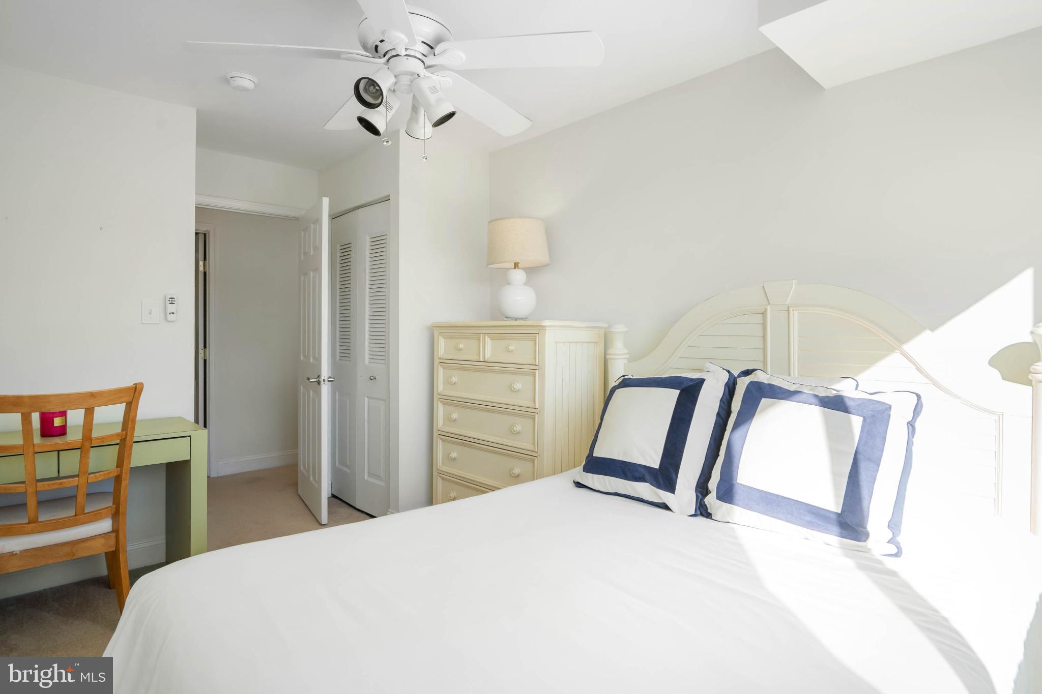 13908 North Ocean Road, Unit 10A Ocean City, MD 21842 - Photo 21 of 29 a bedroom with a bed dresser and a window