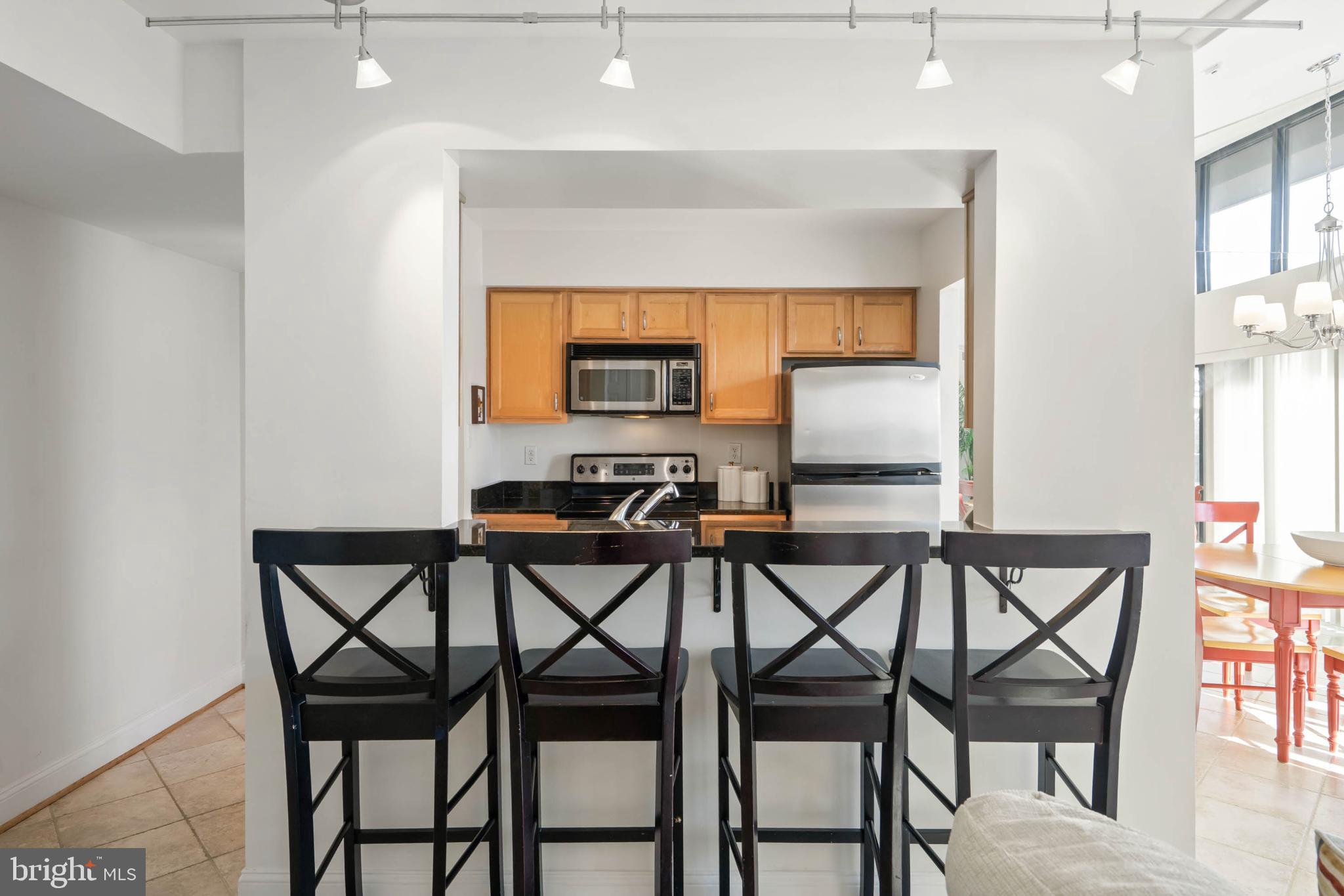 13908 North Ocean Road, Unit 10A Ocean City, MD 21842 - Photo 4 of 29 a view of a dining room with furniture and a window