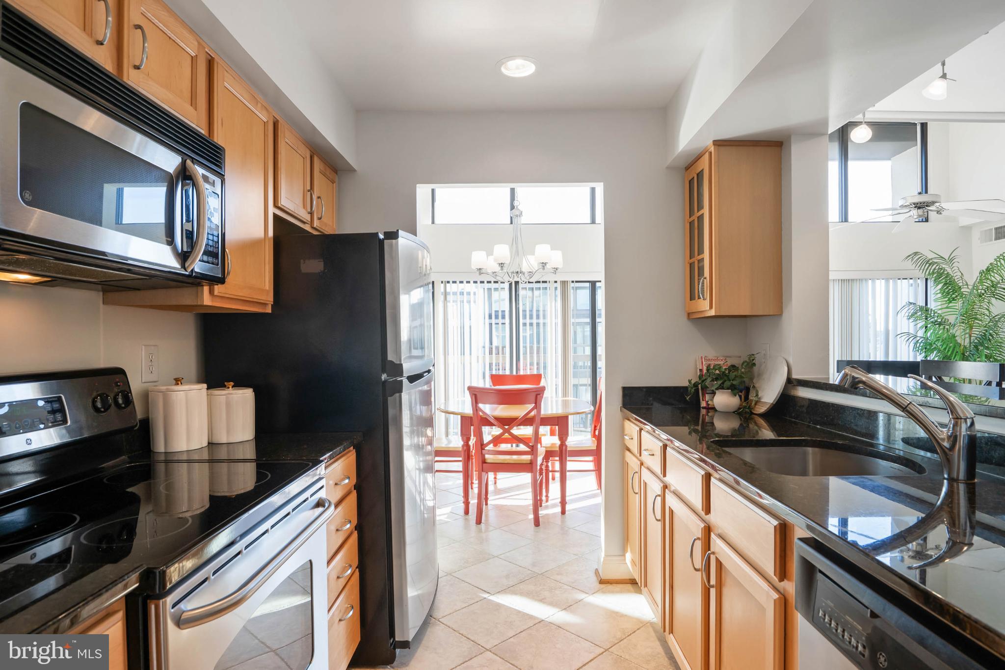 13908 North Ocean Road, Unit 10A Ocean City, MD 21842 - Photo 5 of 29 a kitchen with stainless steel appliances granite countertop a sink stove and refrigerator