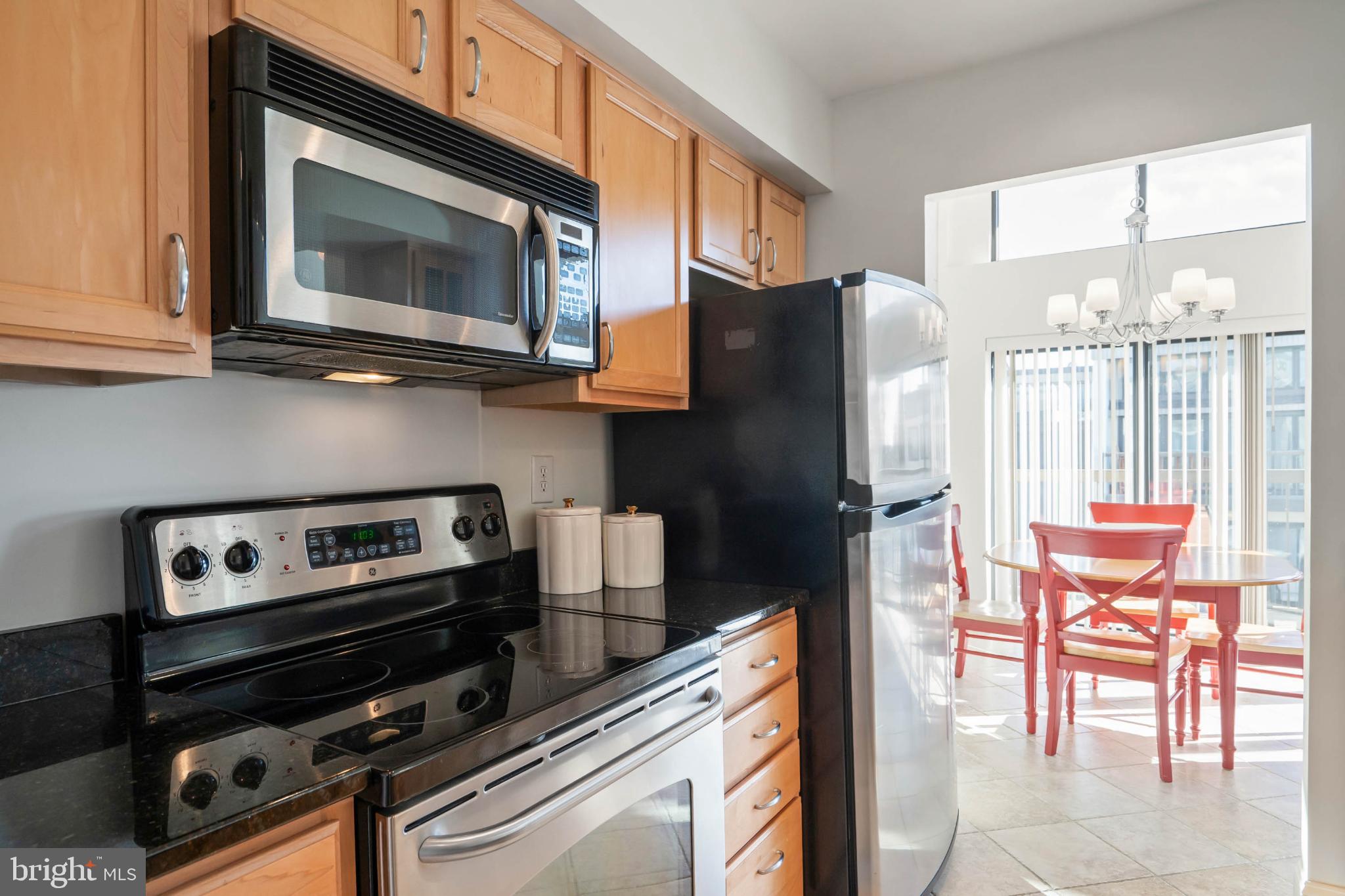 13908 North Ocean Road, Unit 10A Ocean City, MD 21842 - Photo 8 of 29 a kitchen with stainless steel appliances a stove a microwave and a cabinets