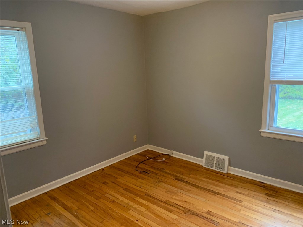 1287 Churchill Road Lyndhurst, OH 44124 - Photo 12 of 27 Empty room featuring a wealth of natural light and light wood-type flooring
