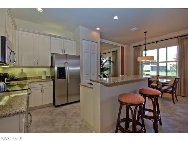 6545 Monterey Point Naples, FL 34105 - Photo 4 of 10 a kitchen with refrigerator and cabinets