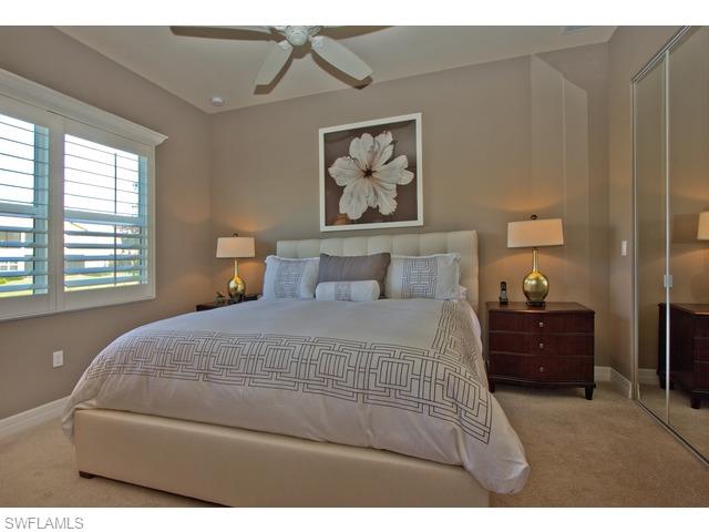 6545 Monterey Point Naples, FL 34105 - Photo 6 of 10 a bedroom with a bed and wooden floor