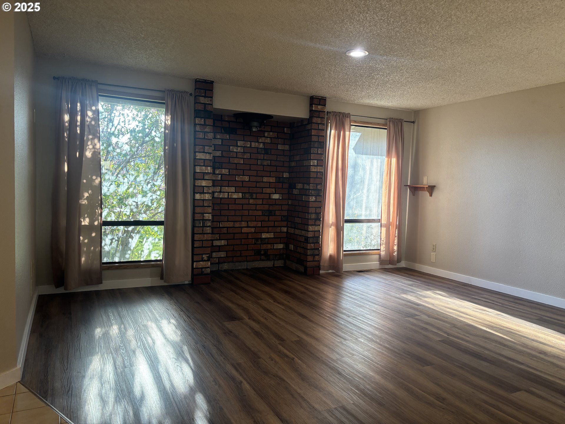 1101 Southwest 37th Street Pendleton, OR 97801 - Photo 4 of 22 an empty room with wooden floor and windows