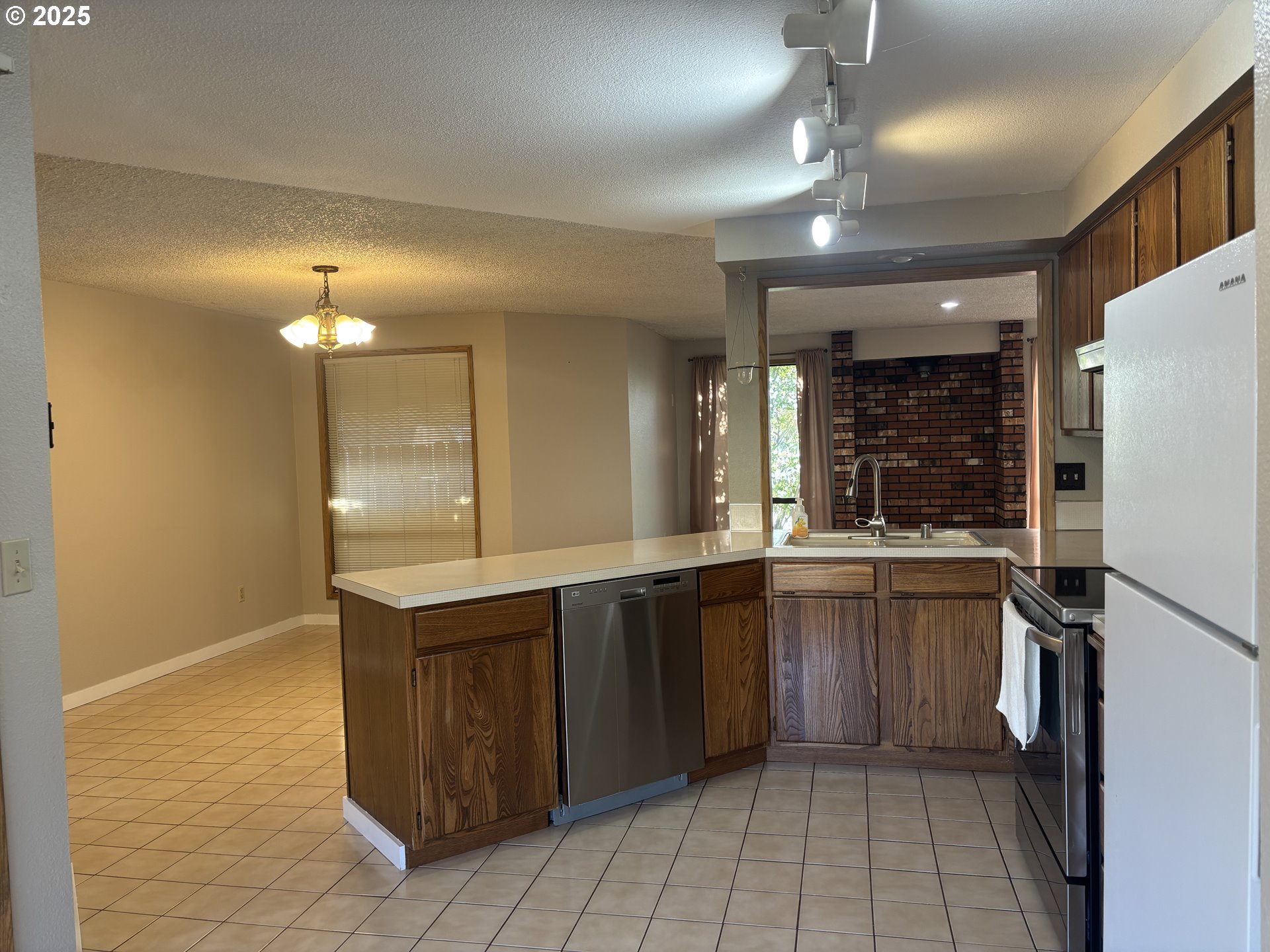 1101 Southwest 37th Street Pendleton, OR 97801 - Photo 6 of 22 a kitchen with a sink a refrigerator and cabinets