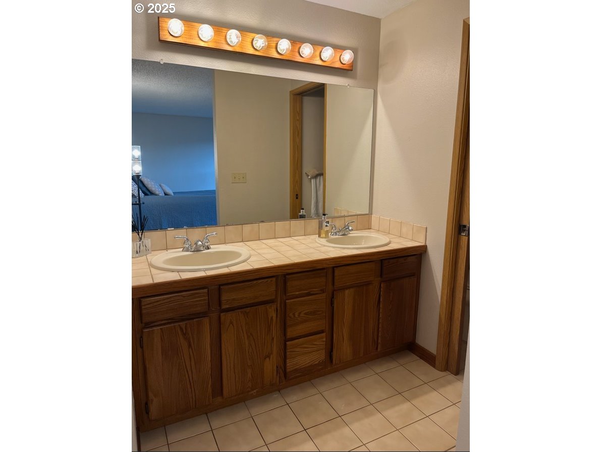 1101 Southwest 37th Street Pendleton, OR 97801 - Photo 9 of 22 a bathroom with a sink and a mirror