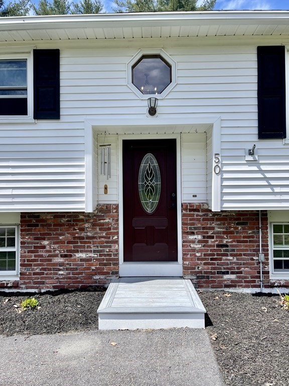 50 Adams Road Townsend, MA 01469 - Photo 3 of 31 a front view of a house with entryway