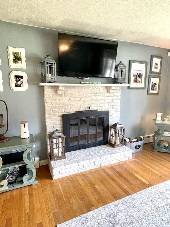 50 Adams Road Townsend, MA 01469 - Photo 8 of 31 a living room with furniture and a fireplace