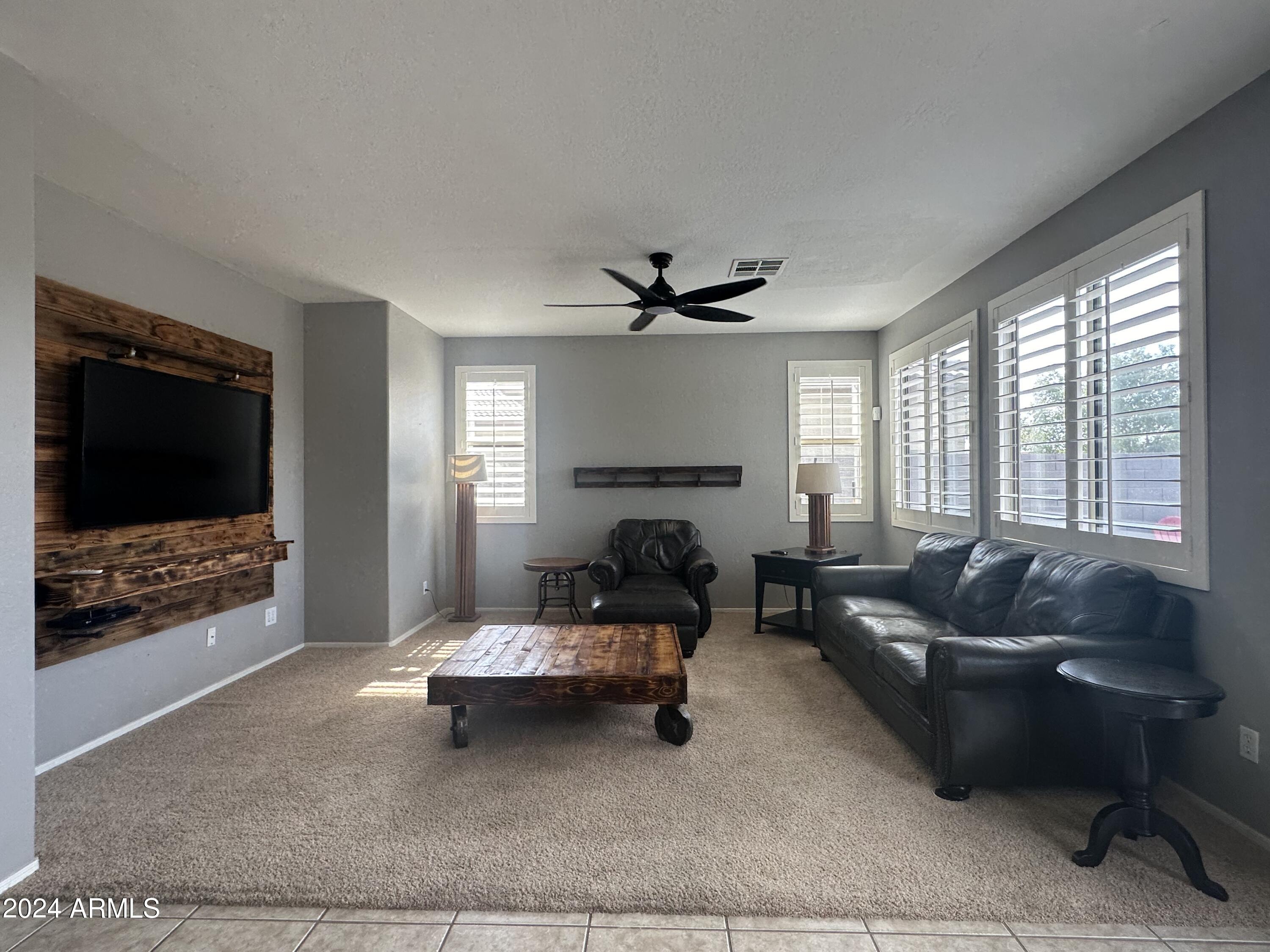 90 West Beechnut Place Chandler, AZ 85248 - Photo 11 of 31 a living room with furniture and a flat screen tv