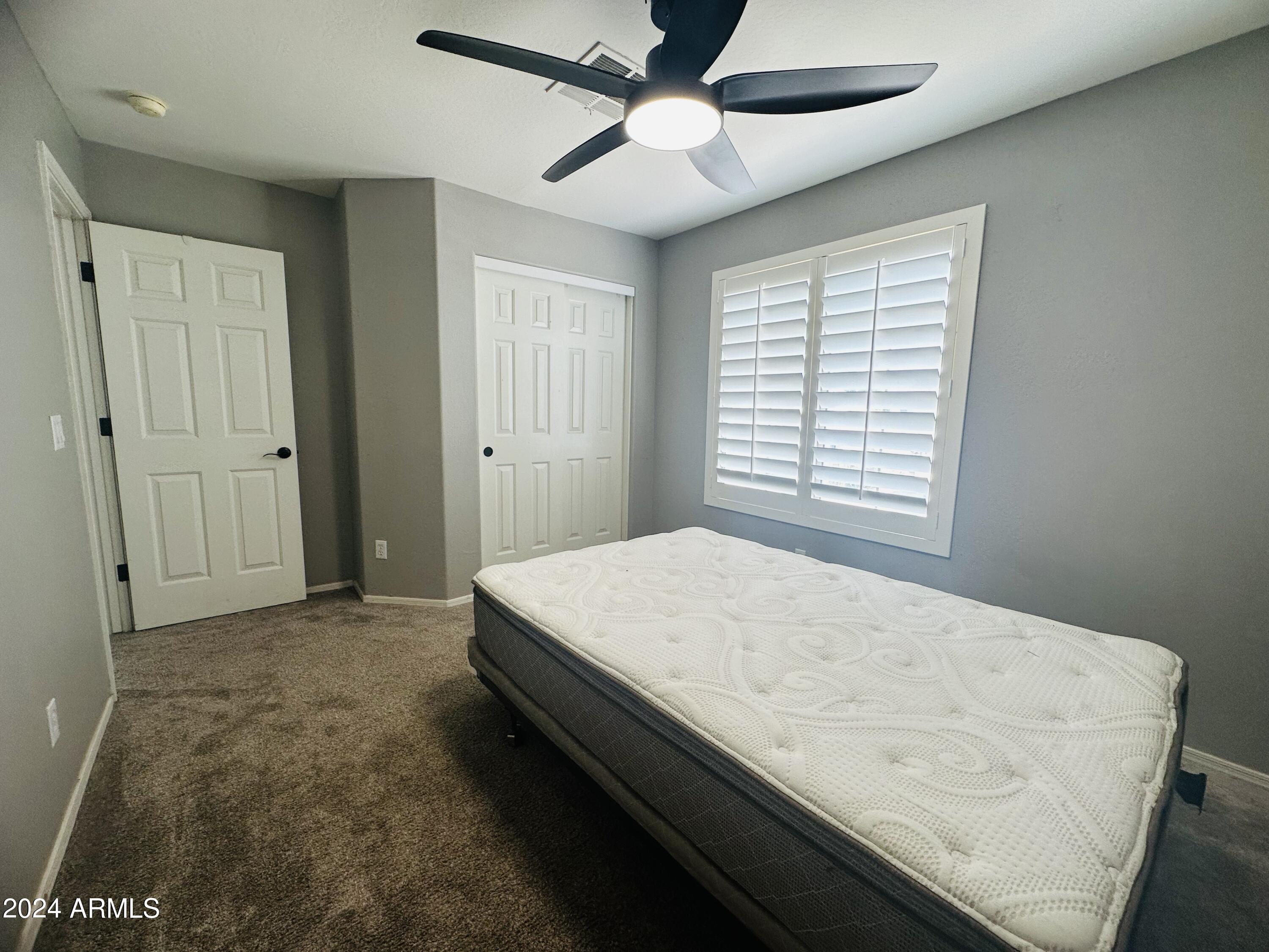 90 West Beechnut Place Chandler, AZ 85248 - Photo 22 of 31 a bed sitting in a spacious bedroom next to a window