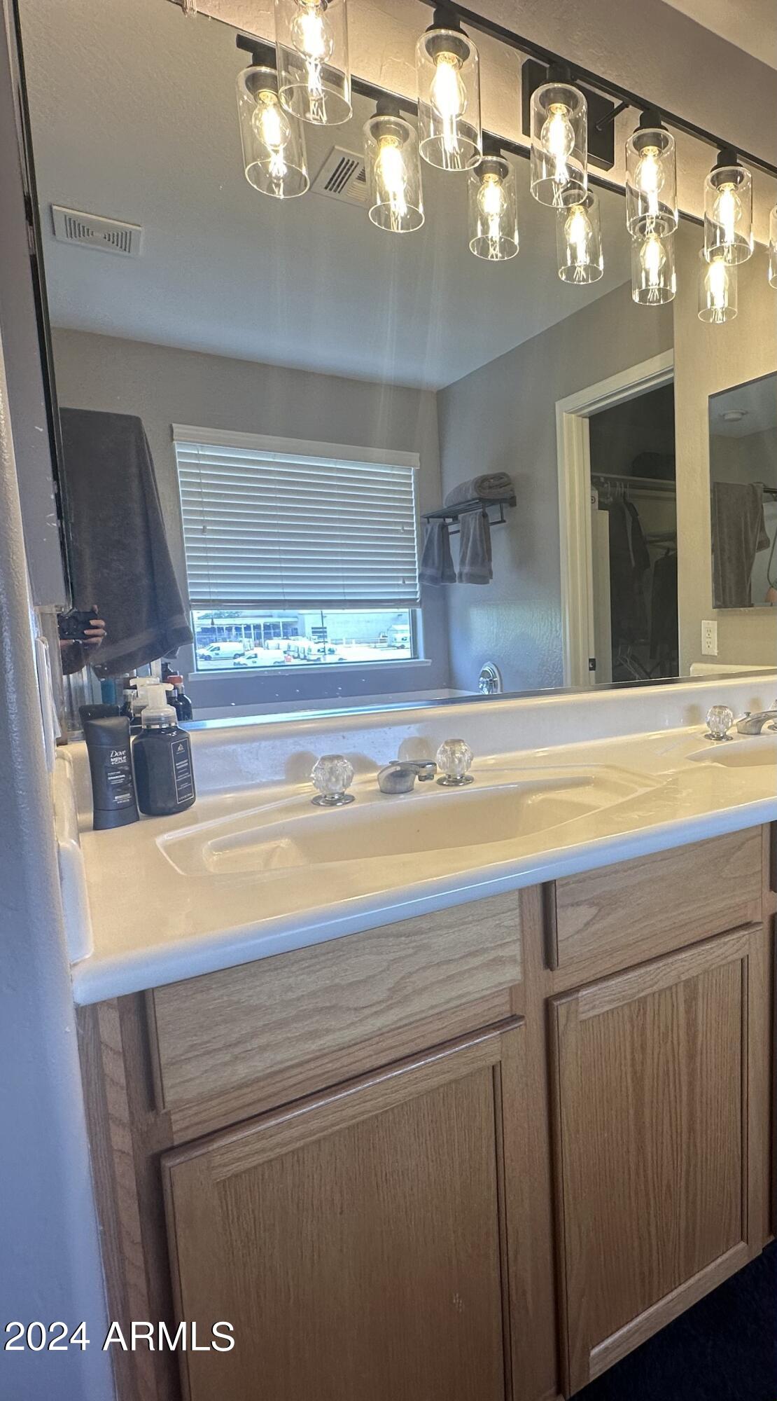 90 West Beechnut Place Chandler, AZ 85248 - Photo 25 of 31 a bathroom with a sink a large mirror and vanity