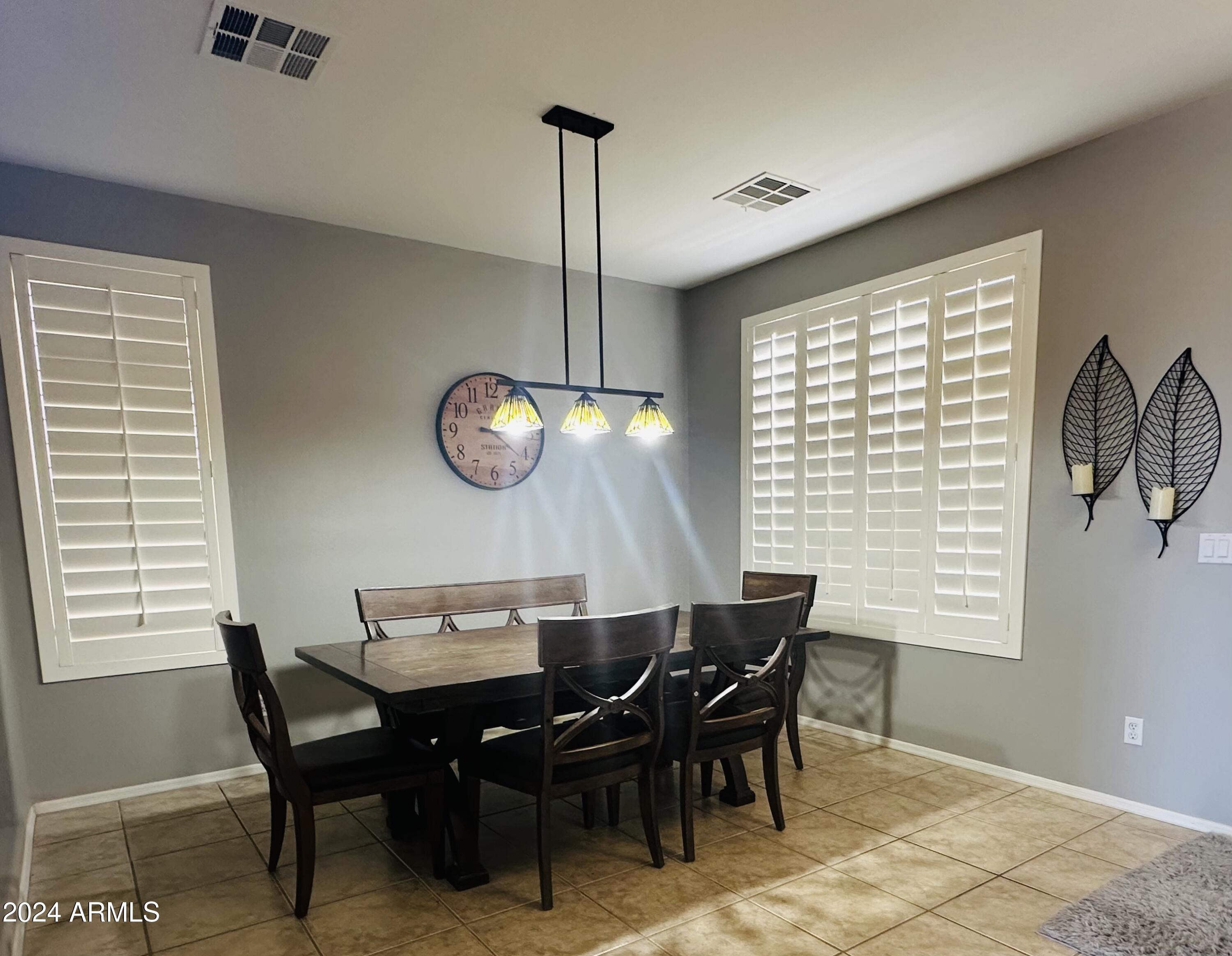 90 West Beechnut Place Chandler, AZ 85248 - Photo 7 of 31 a view of a dining room with furniture window and wooden floor