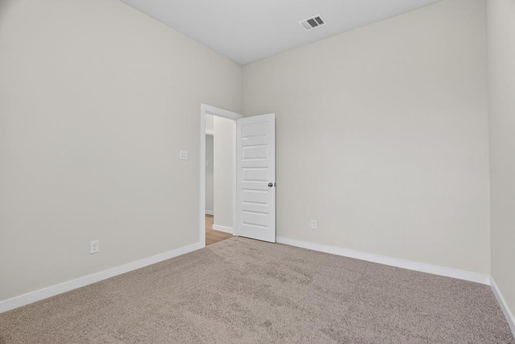 321 Skeen Peak Springtown, TX 76082 - Photo 27 of 37 Neutral-toned carpeting paired with light walls and white trim
