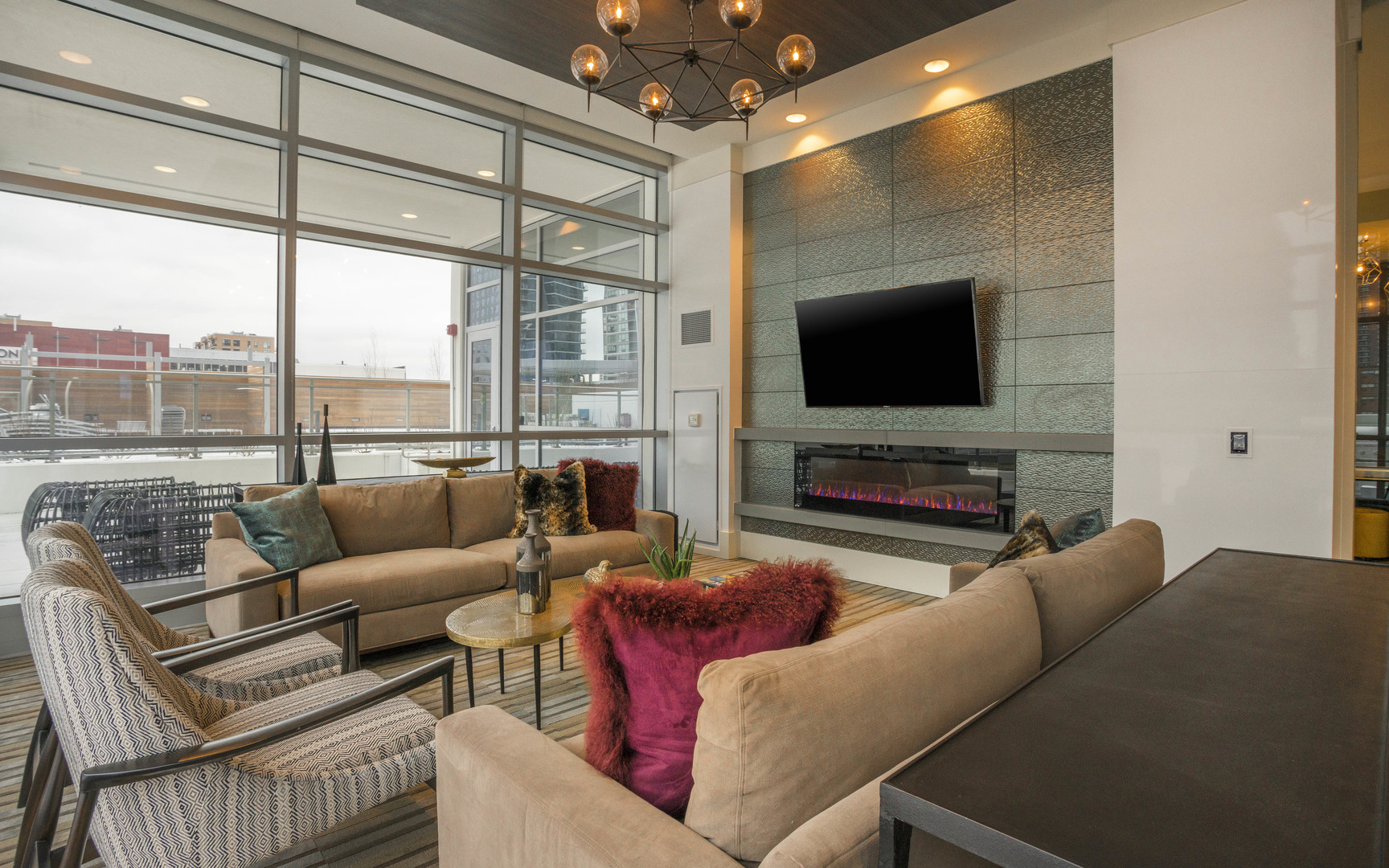 801 South Financial Place, Unit 605 Chicago, IL 60607 - Photo 19 of 31 a living room with furniture a flat screen tv and a floor to ceiling window