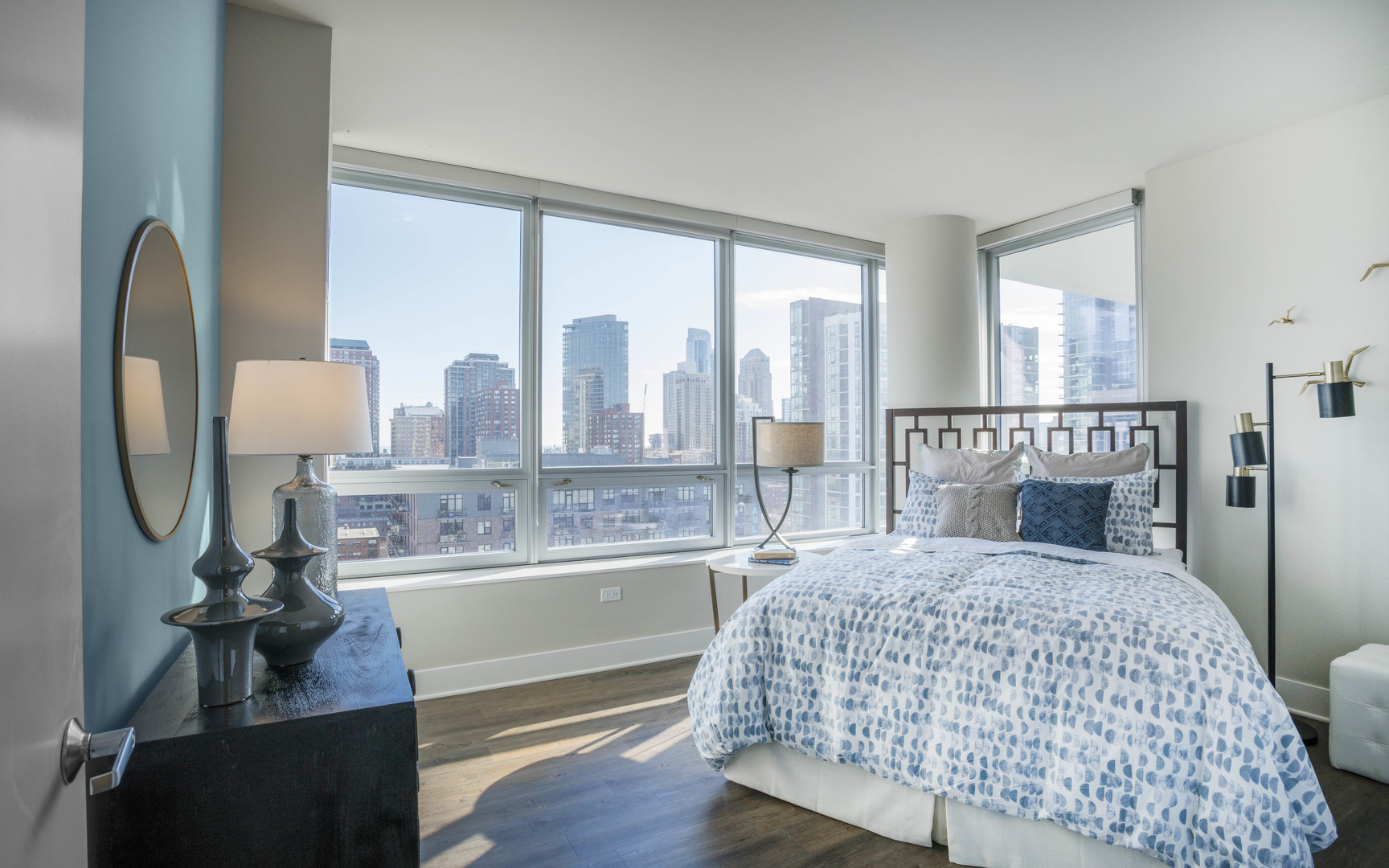 801 South Financial Place, Unit 605 Chicago, IL 60607 - Photo 6 of 31 a bedroom with a large bed and a chandelier