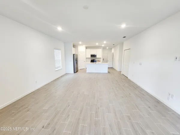 a view of a kitchen with a sink and a stove top oven