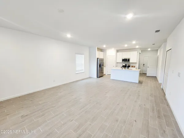 a view of a kitchen with a sink and a refrigerator