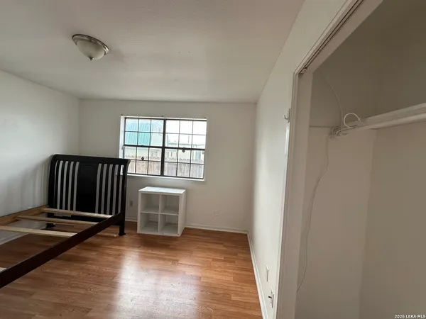 a view of a hallway with wooden floor and stairs