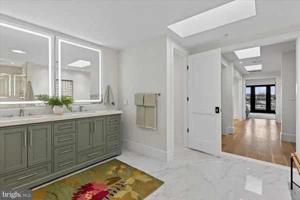 a view of a hallway with a potted plant and a mirror