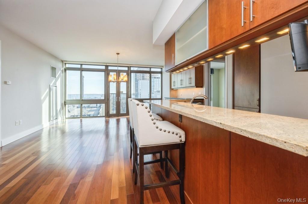 175 Huguenot Street, Unit 1604 New Rochelle, NY 10801 - Photo 2 of 24 Open kitchen layout to dining area and living room with Juliette doors.