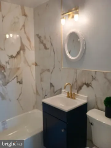 a bathroom with a sink a toilet and a bathtub