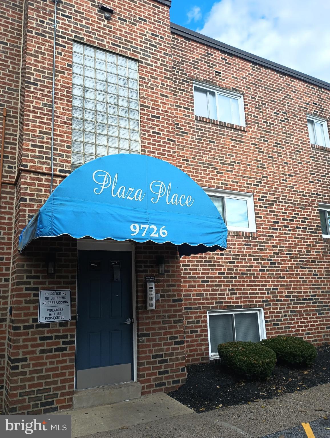 9712-26 Bustleton Avenue, Unit 8 Philadelphia, PA 19115 - Photo 6 of 6 a front view of a building with a garden