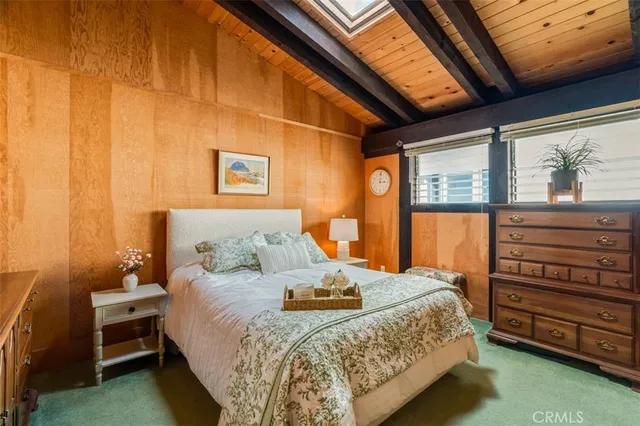 a spacious bedroom with a bed and a large window