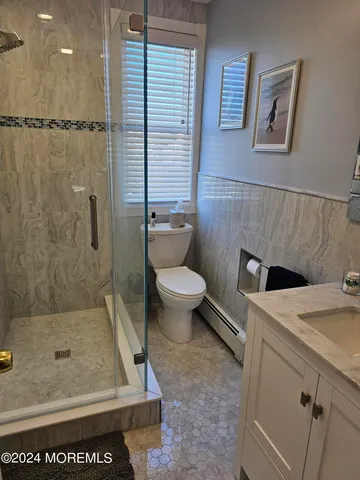 a bathroom with a toilet sink and shower