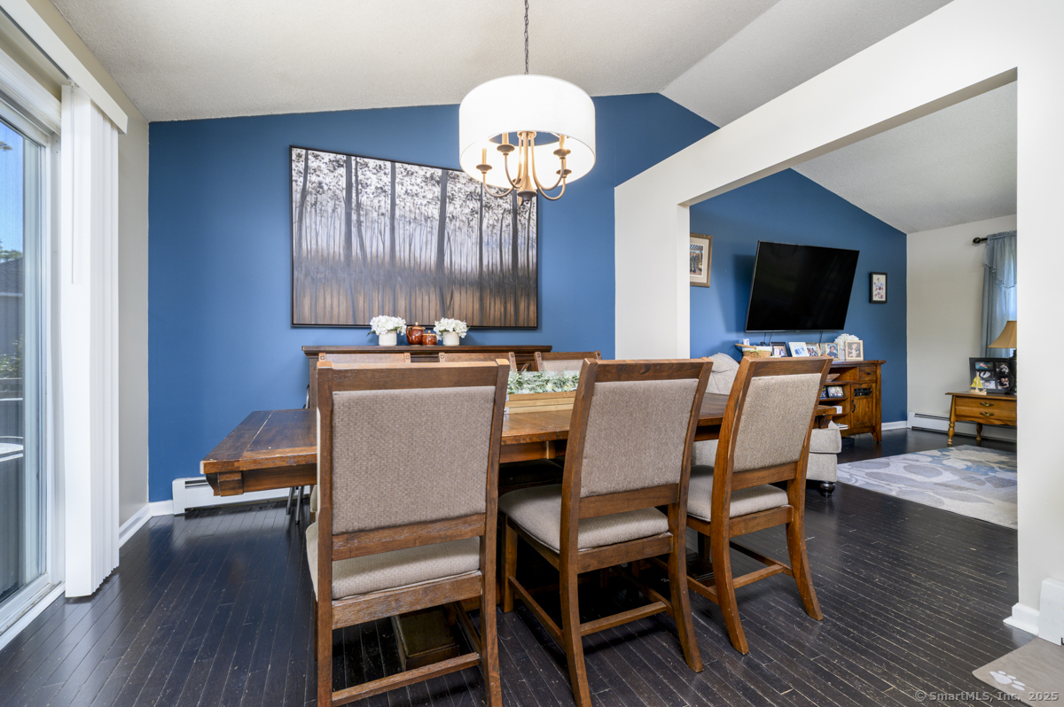 10 Hoinski Way Ansonia, CT 06401 - Photo 15 of 30 a dining room with wooden floor a chandelier a wooden table and chairs