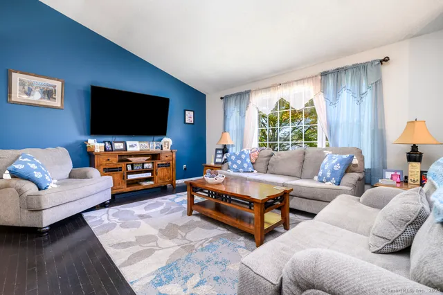 a living room with furniture and a flat screen tv