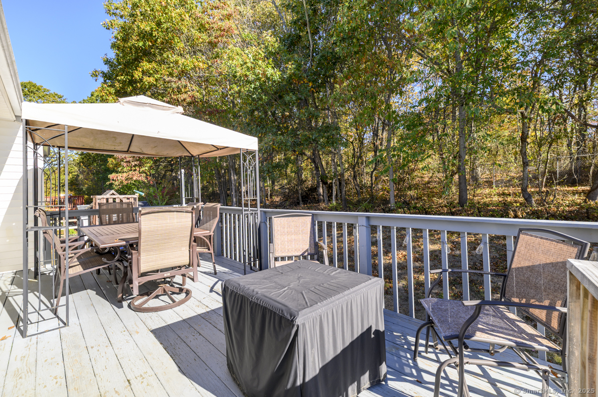 10 Hoinski Way Ansonia, CT 06401 - Photo 19 of 30 a view of deck with furniture and umbrella