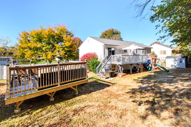 a view of a house with a wooden deck