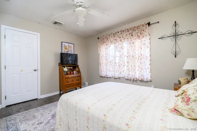 a bedroom with a bed and a window