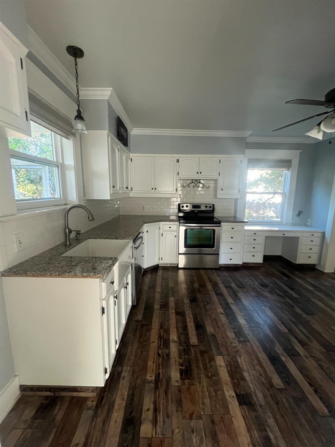 471 South Reed Avenue Reedley, CA 93654 - Photo 21 of 54 a kitchen with kitchen island granite countertop a sink stove and refrigerator