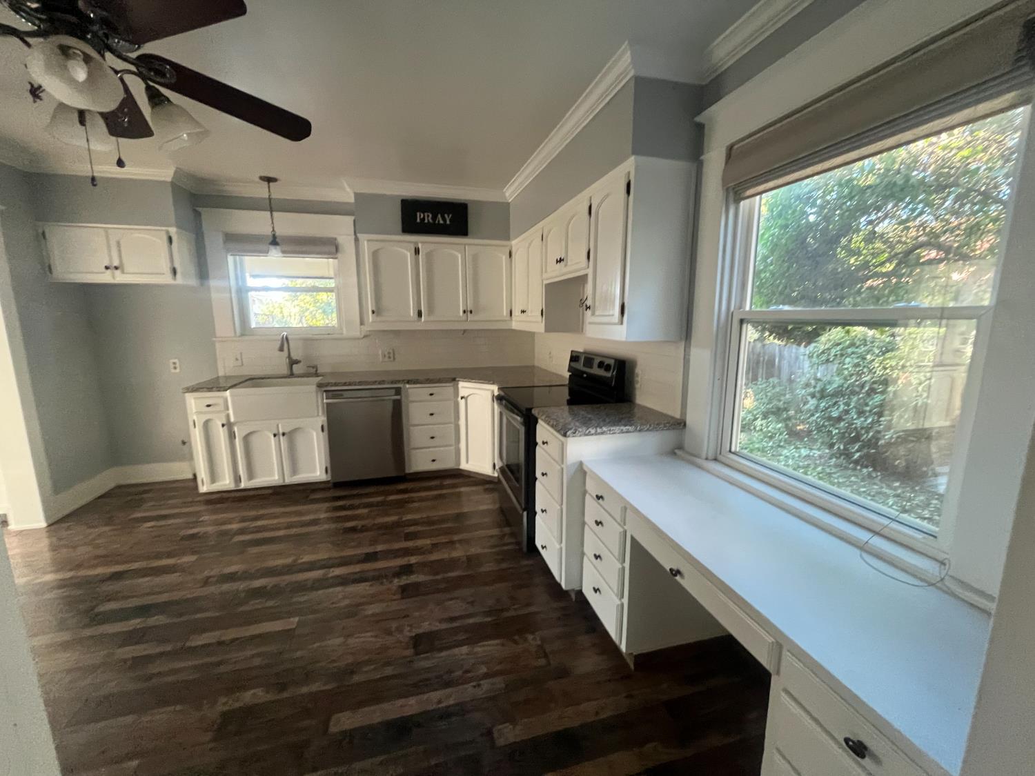471 South Reed Avenue Reedley, CA 93654 - Photo 28 of 54 a kitchen with stainless steel appliances granite countertop a lot of counter space and wooden floors