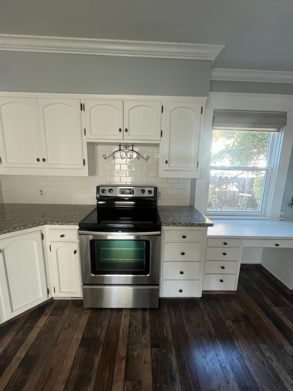 471 South Reed Avenue Reedley, CA 93654 - Photo 33 of 54 a kitchen with a stove and white cabinets