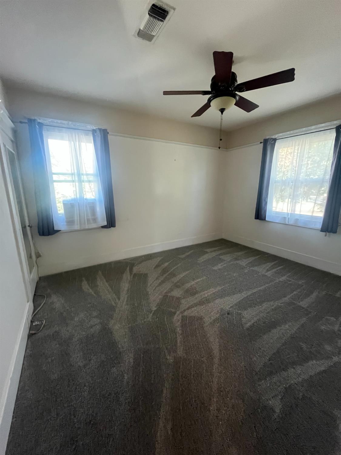 471 South Reed Avenue Reedley, CA 93654 - Photo 36 of 54 en empty room with windows and fan