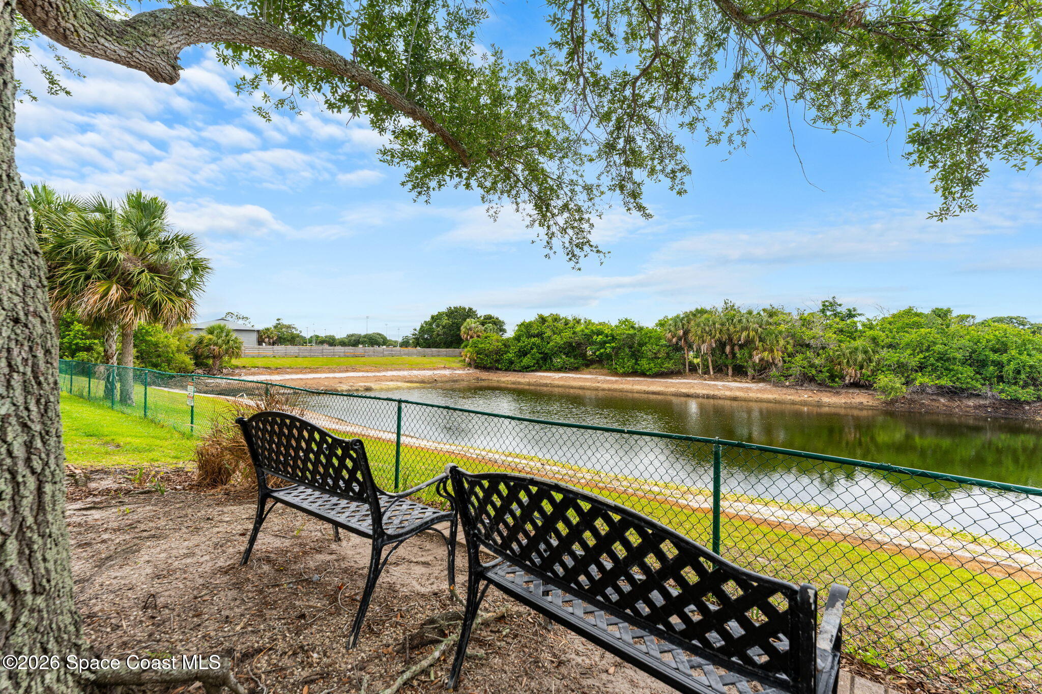 110 Turpial Way, Unit 106 Melbourne, FL 32901 - Photo 6 of 50 a view of a lake with couches in the patio next to a yard