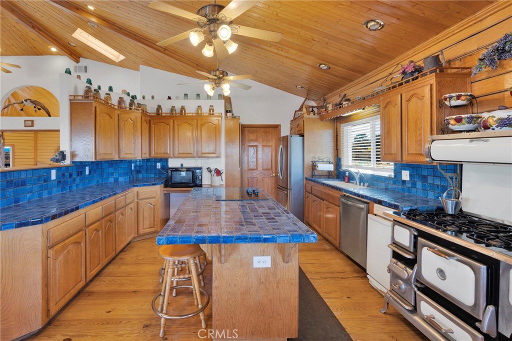 10328 El Centro Road Oak Hills, CA 92344 - Photo 11 of 43 a kitchen with stainless steel appliances granite countertop a sink and cabinets